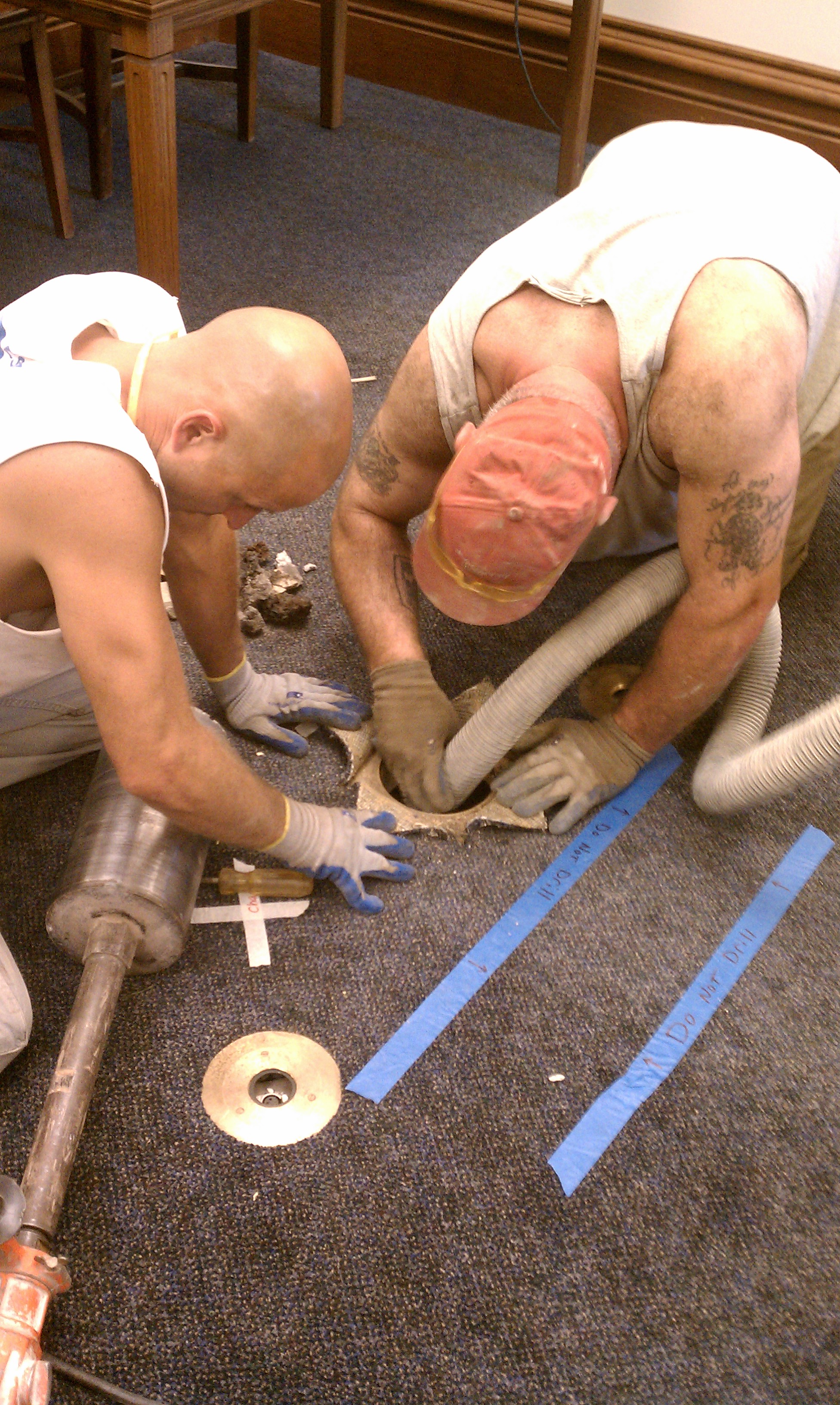 floor pic of mike and matt cleaning the hole.jpg